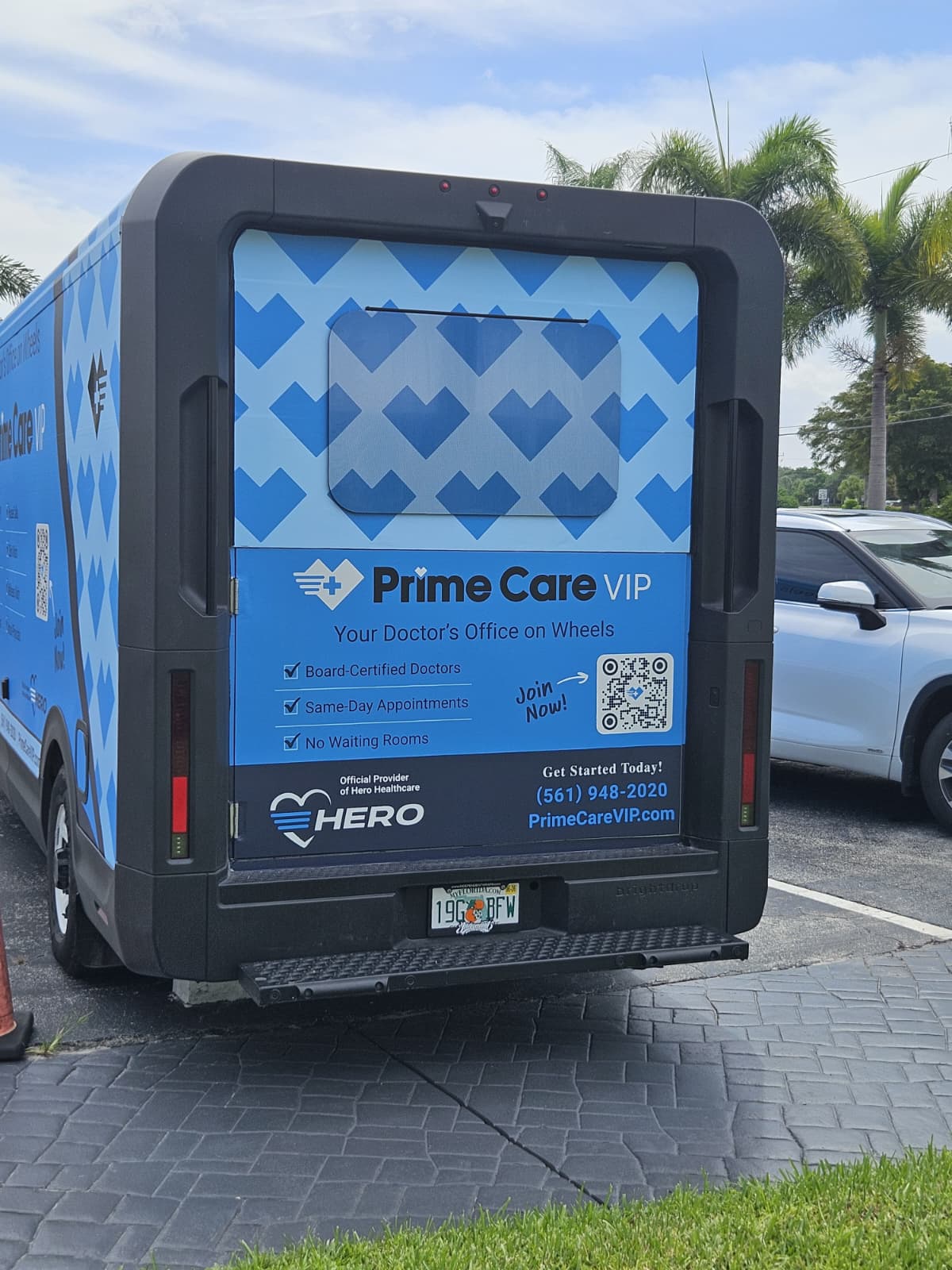 Rear of a Boca Motor Coach mobile clinic with custom heart-pattern wrap